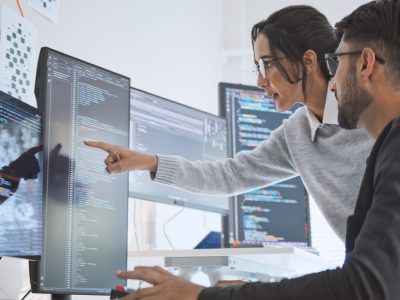Hispanic Latin American couple, software engineer developer use computer, work on program coding together at home office. Programming language development technology, freelance job concept