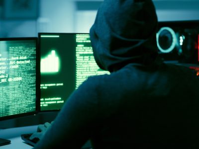 Back of hacker, person and dark computer for cybersecurity, ransomware and data password for crime. Error, thief and spy coding pc software for scam, phishing and hacking online firewall with malware