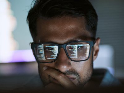 Hispanic Latin American man, software engineer developer use computer at home office, work on program coding at night. Programming language development technology, freelance work from home concept