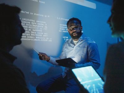 The software engineering team is meeting to review code and enhance the capabilities of the artificial intelligence